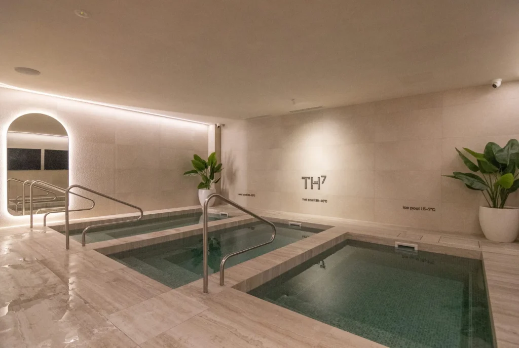 Three plunge pools in a beige tiled room